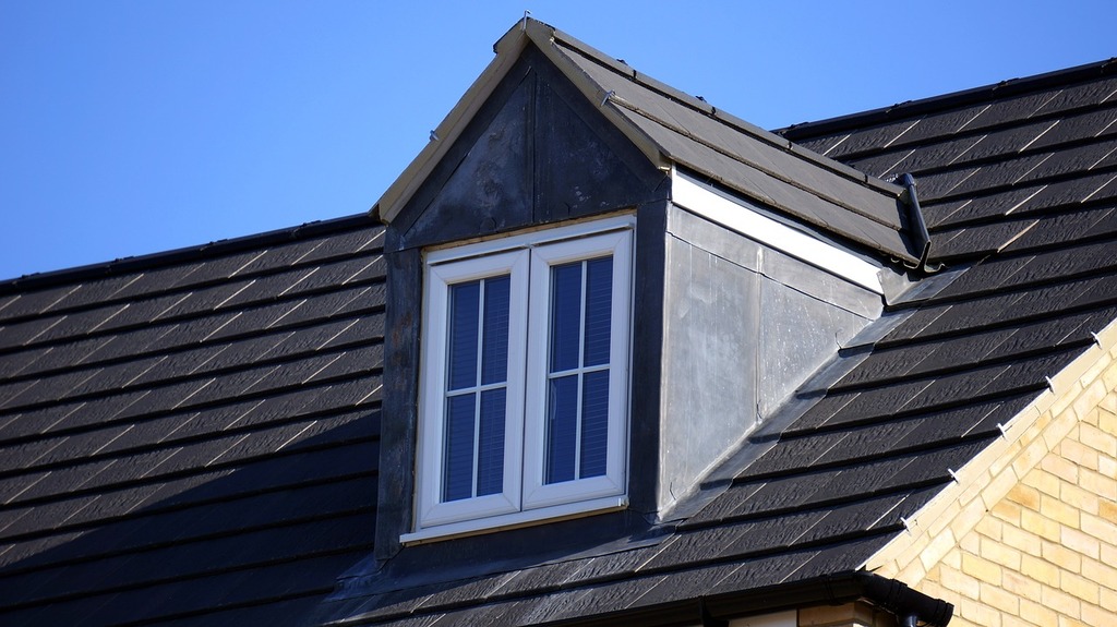 Window house home building. A black roof with a white window on top of it
